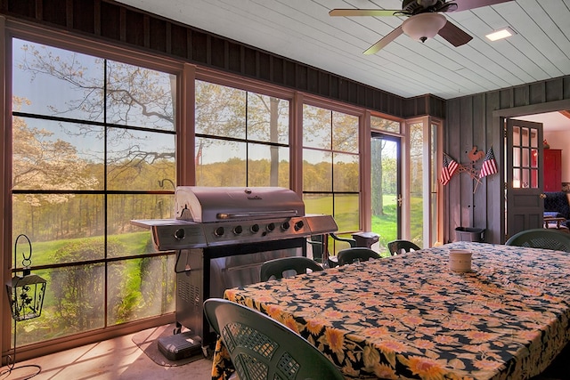 bedroom featuring wooden walls, light tile patterned flooring, wooden ceiling, and ceiling fan