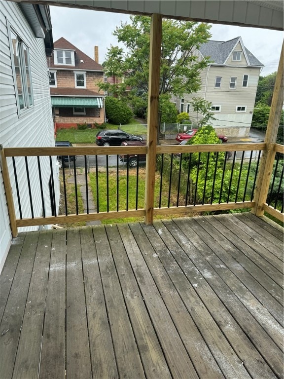 wooden terrace featuring a yard