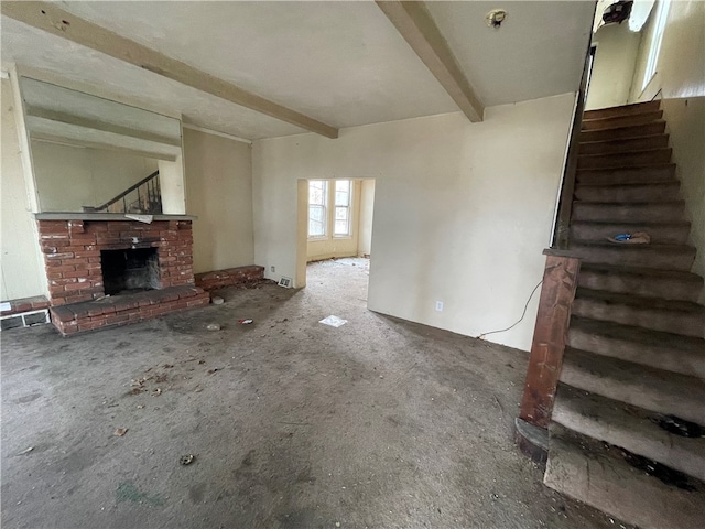 unfurnished living room with beam ceiling and a fireplace