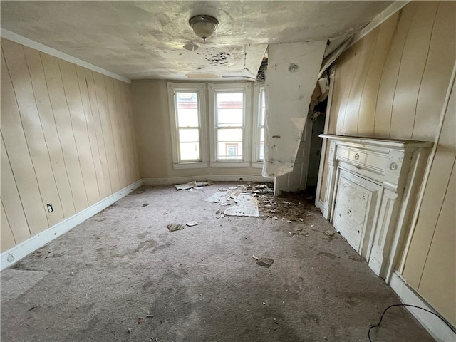 unfurnished living room featuring wooden walls