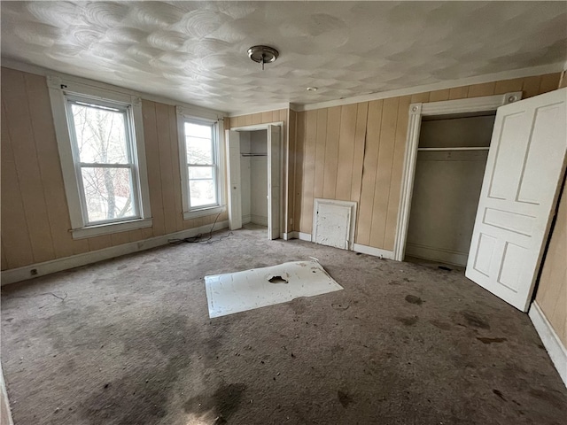 unfurnished bedroom with wooden walls