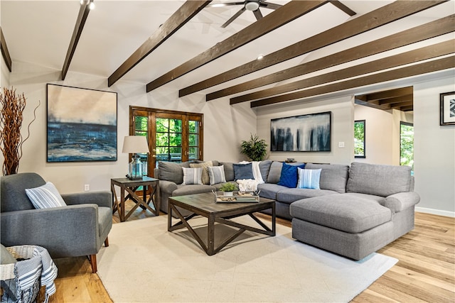 living room with ceiling fan, beam ceiling, and light hardwood / wood-style flooring