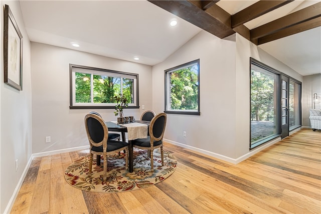 dining room featuring lofted ceiling with beams, french doors, and light wood-type flooring