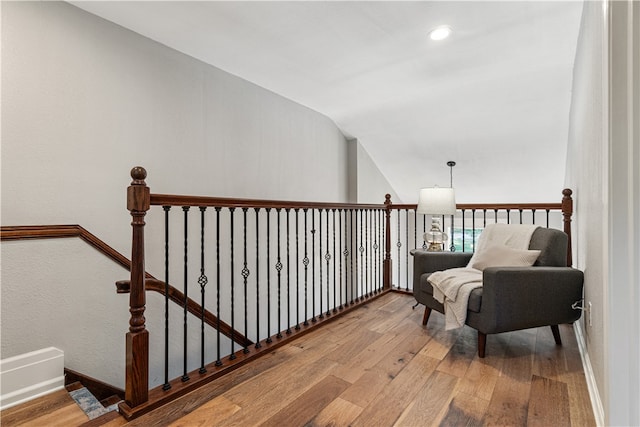 sitting room featuring vaulted ceiling and hardwood / wood-style flooring