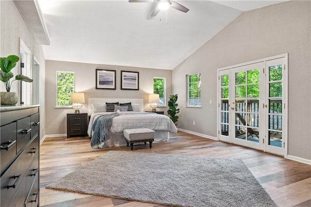 bedroom with multiple windows, light hardwood / wood-style floors, and access to outside