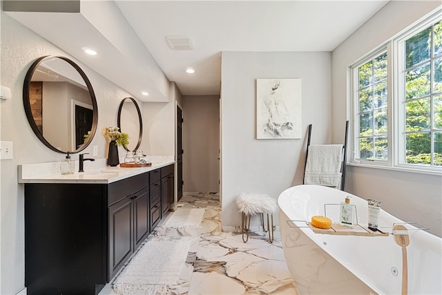 bathroom with tile flooring, dual vanity, and a bath to relax in