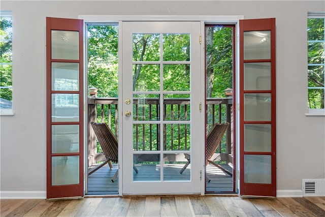 doorway to outside featuring french doors and hardwood / wood-style floors