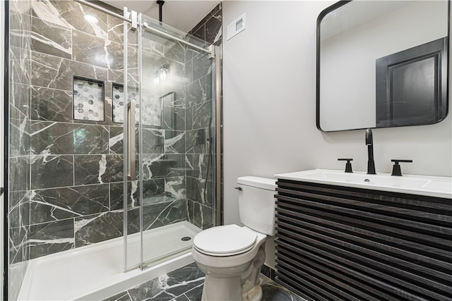 bathroom featuring walk in shower, vanity, toilet, and tile floors