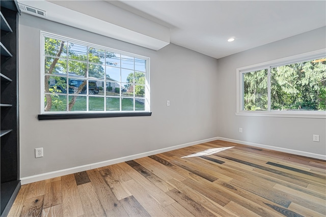 unfurnished room with hardwood / wood-style floors