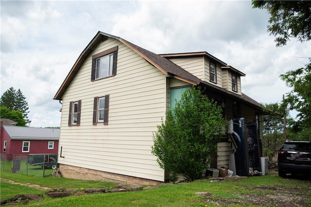 view of side of property with a yard