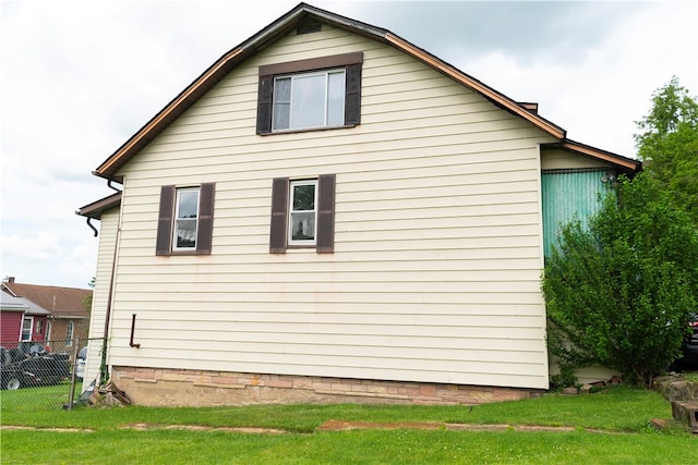 view of side of home featuring a yard