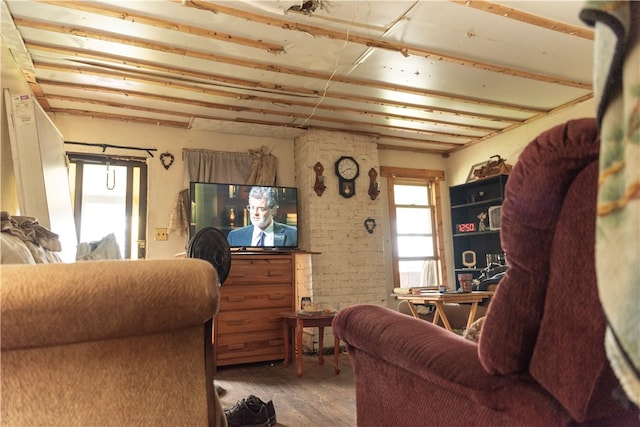 living room featuring light hardwood / wood-style flooring and brick wall