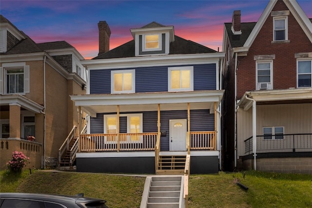 view of front of property featuring a yard and a porch