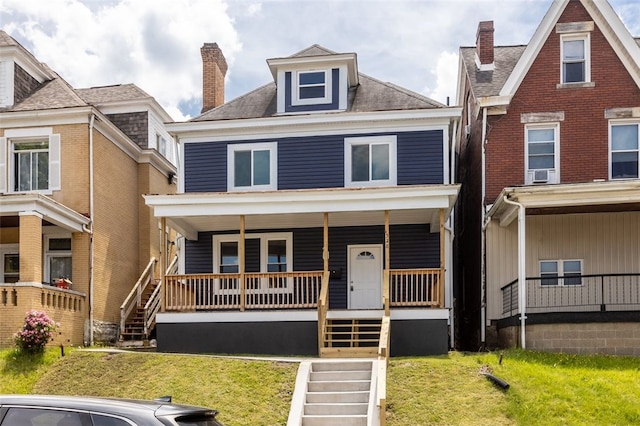 view of front facade featuring covered porch and a front yard