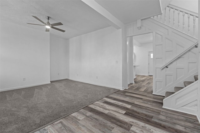 interior space with dark colored carpet and ceiling fan