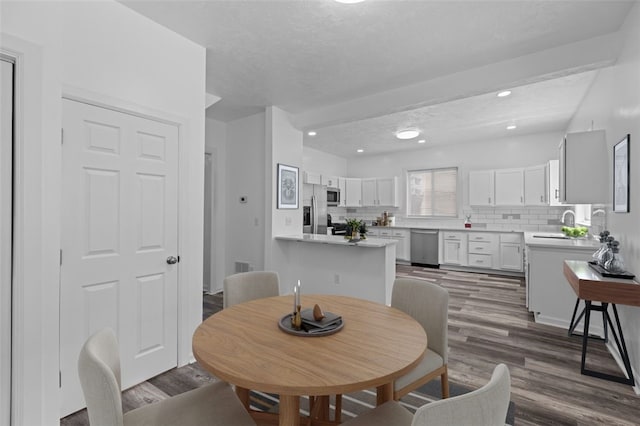 dining space with dark wood-type flooring and sink