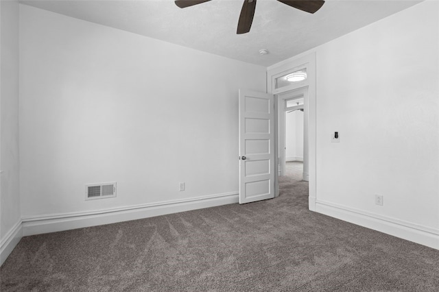 unfurnished room featuring dark colored carpet and ceiling fan