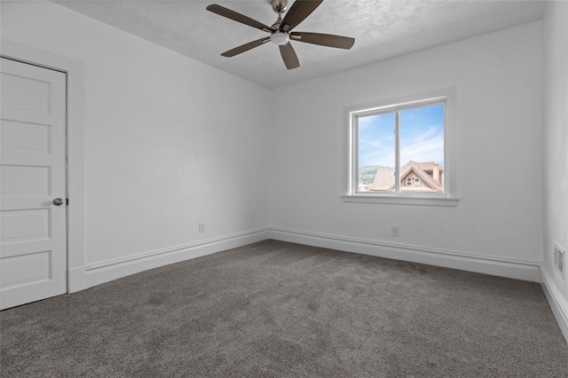 empty room with ceiling fan and carpet floors