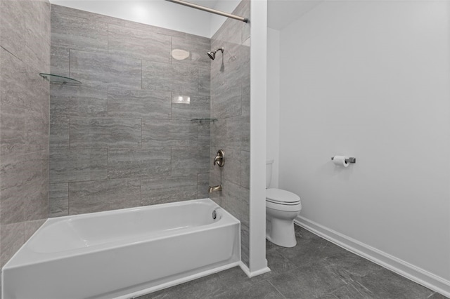 bathroom featuring tile flooring, toilet, and tiled shower / bath combo