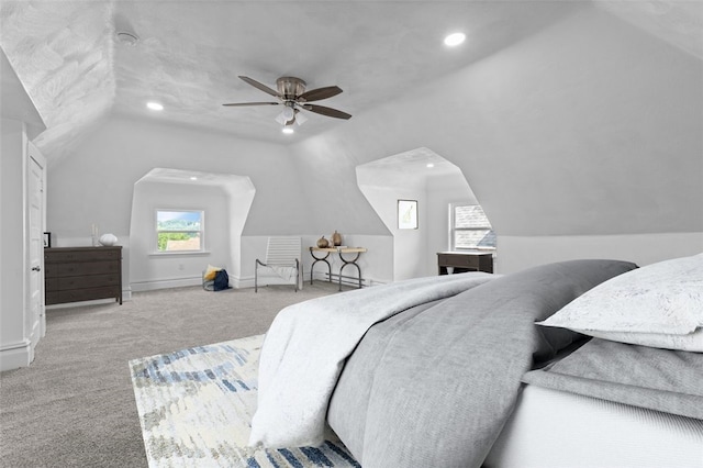 bedroom with ceiling fan, lofted ceiling, and light carpet