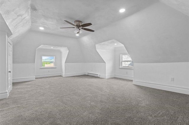 bonus room with a baseboard heating unit, vaulted ceiling, ceiling fan, and carpet floors