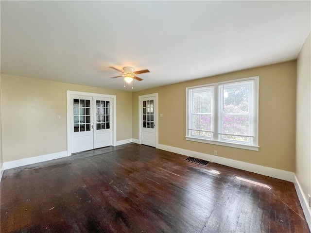 unfurnished room featuring french doors, dark hardwood / wood-style floors, and ceiling fan