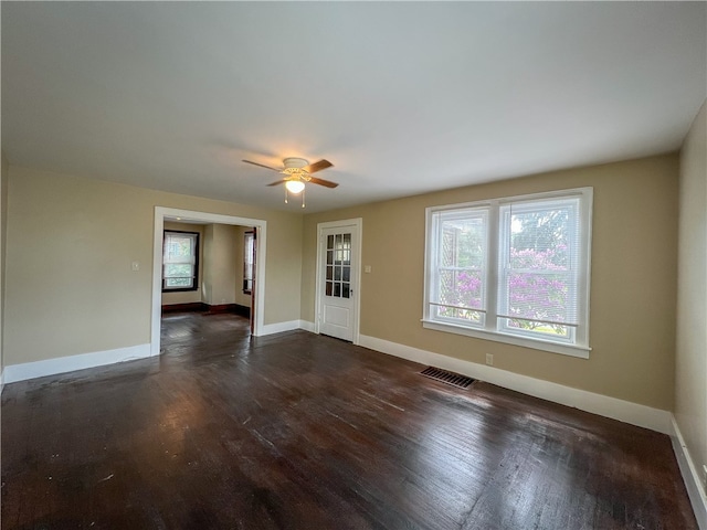 unfurnished room with ceiling fan and dark hardwood / wood-style floors