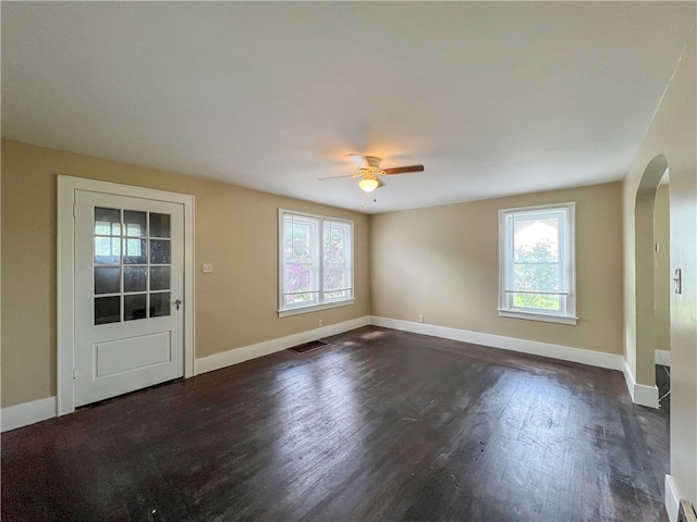 unfurnished room with ceiling fan and dark hardwood / wood-style flooring