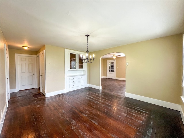 unfurnished dining area featuring dark hardwood / wood-style floors and a notable chandelier