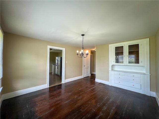 interior space with dark hardwood / wood-style flooring and a chandelier