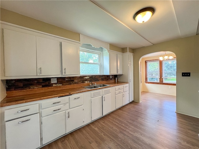 kitchen featuring plenty of natural light, sink, white cabinets, and hardwood / wood-style flooring