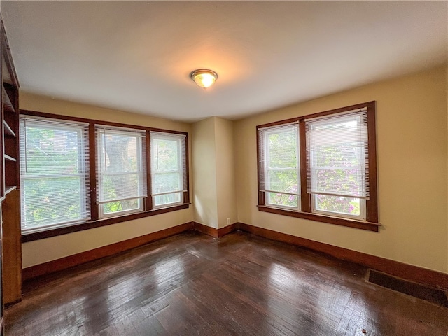 empty room with dark hardwood / wood-style floors