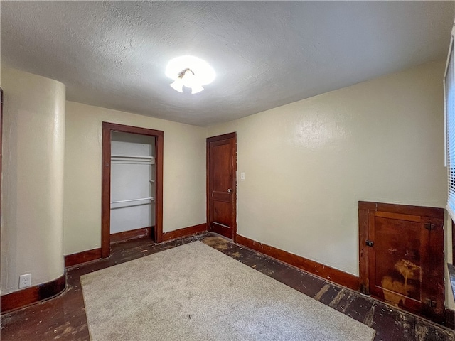 unfurnished room featuring a textured ceiling