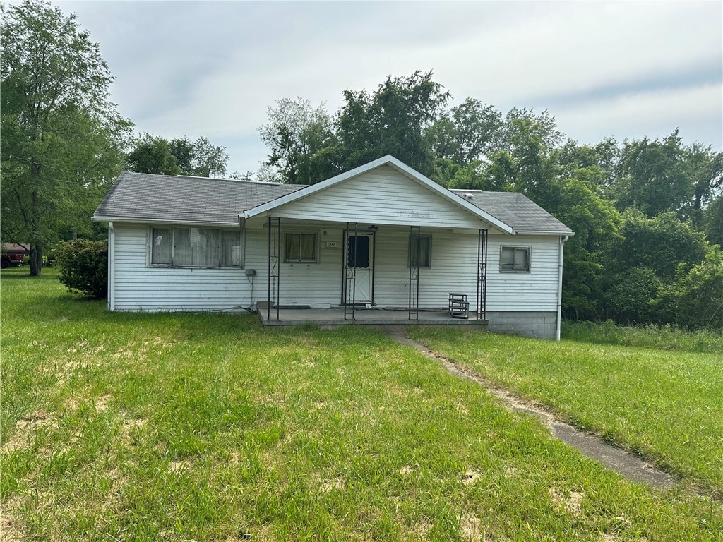 ranch-style house featuring a porch and a front lawn