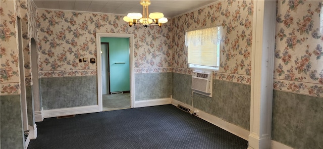 spare room featuring carpet and an inviting chandelier