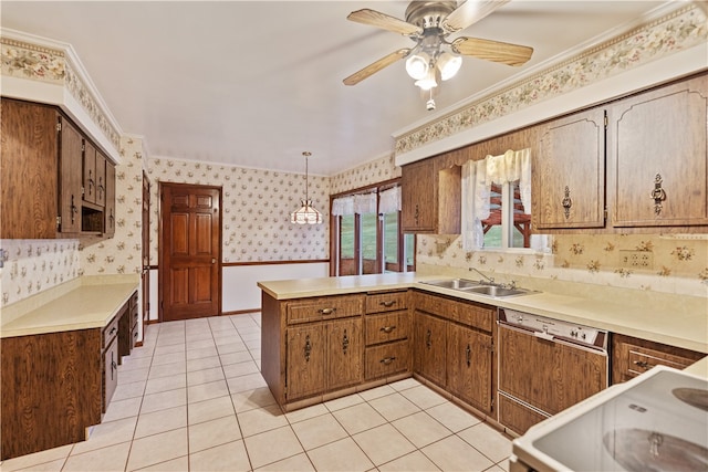 kitchen featuring pendant lighting, kitchen peninsula, sink, and ornamental molding