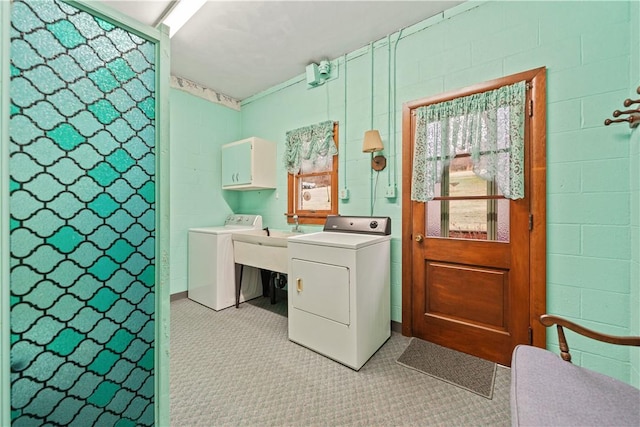 laundry area with washer and clothes dryer and cabinets