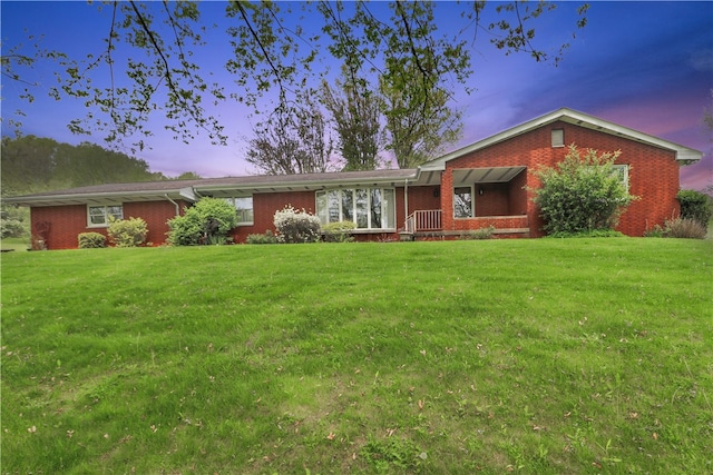 ranch-style home featuring a yard