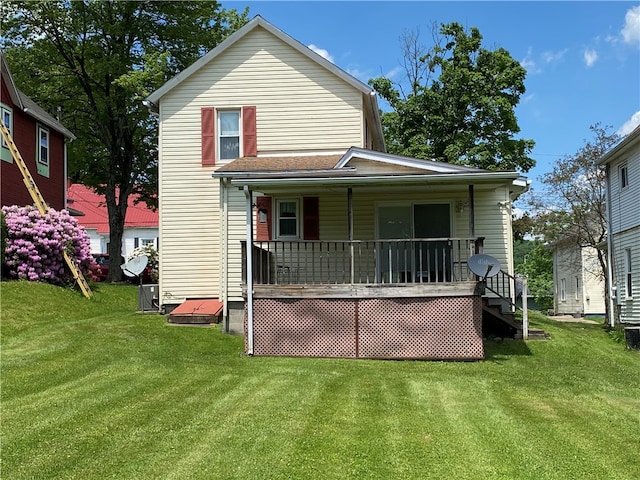 back of property with a porch and a lawn