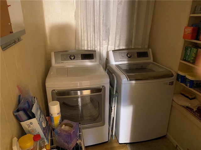 clothes washing area with separate washer and dryer