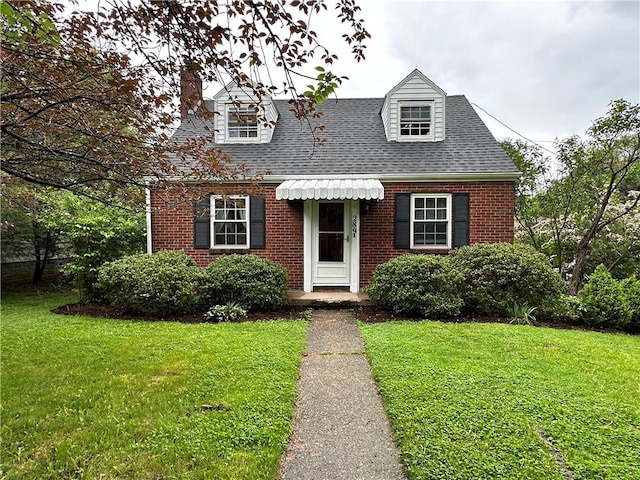 new england style home with a front yard