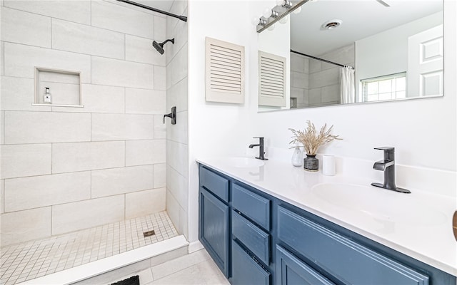 bathroom with tile patterned floors, vanity, and curtained shower