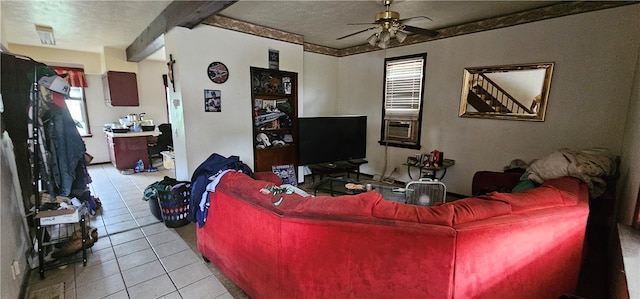 tiled living room with ceiling fan, a textured ceiling, and beam ceiling