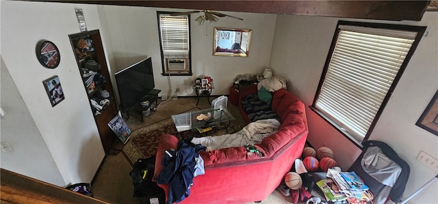 carpeted living room with ceiling fan