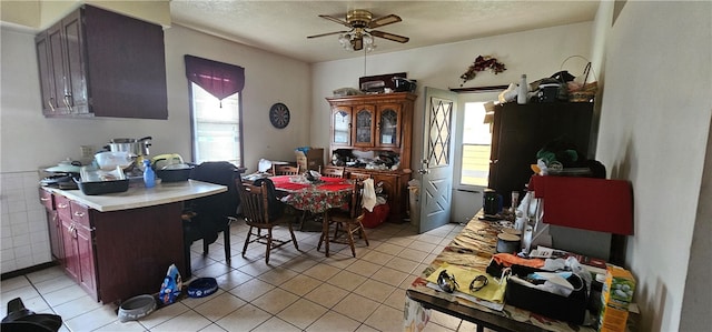 tiled dining room featuring ceiling fan