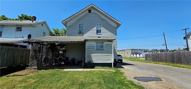 back of property featuring a yard