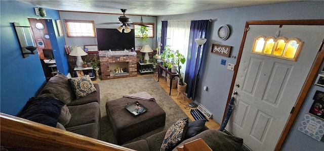 living room featuring a fireplace and ceiling fan