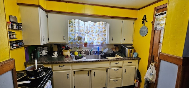 kitchen with crown molding, sink, and tasteful backsplash