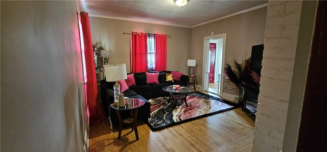 living room with hardwood / wood-style floors and crown molding