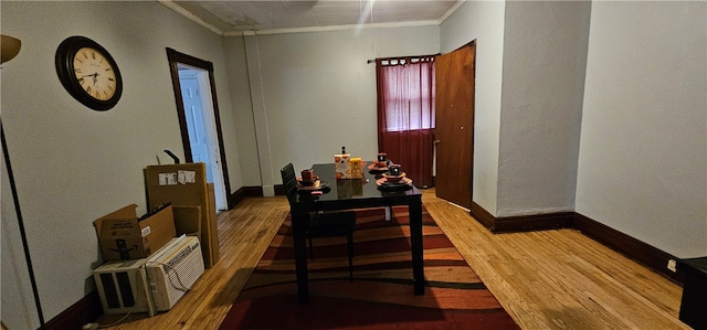 dining space with hardwood / wood-style floors and crown molding